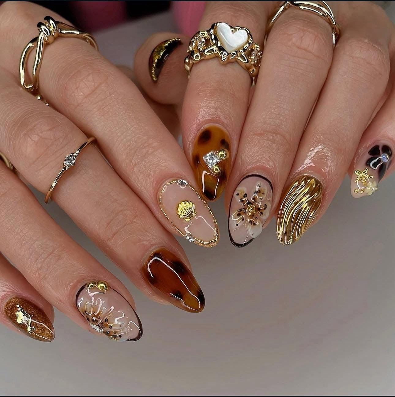 Hand wearing brown Almond -shaped press-on nails