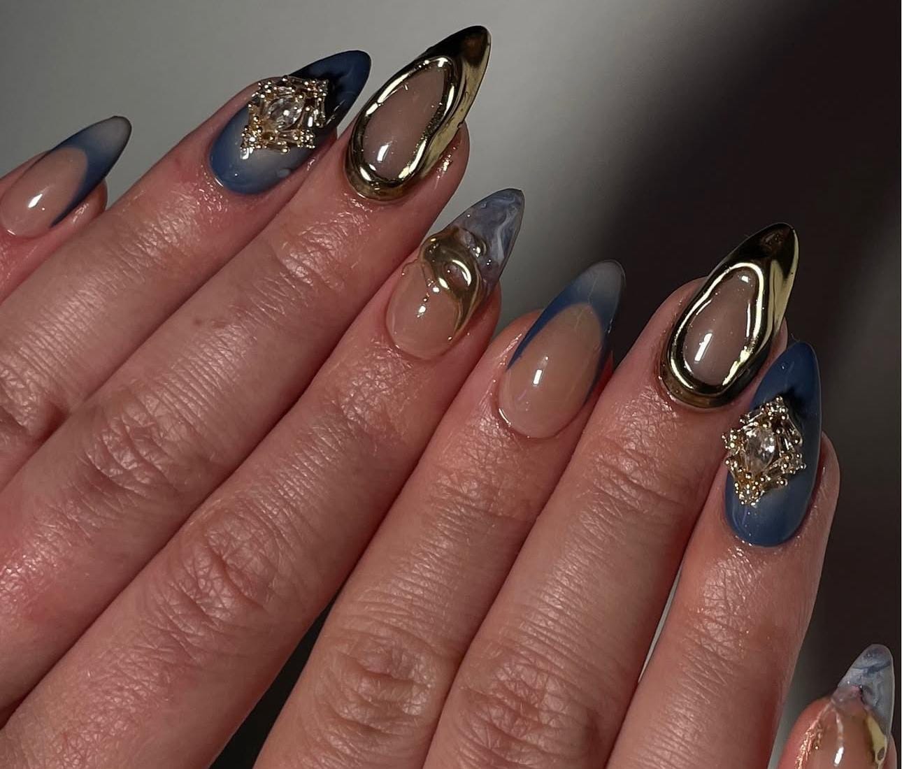 Hand wearing blue Almond -shaped press-on nails