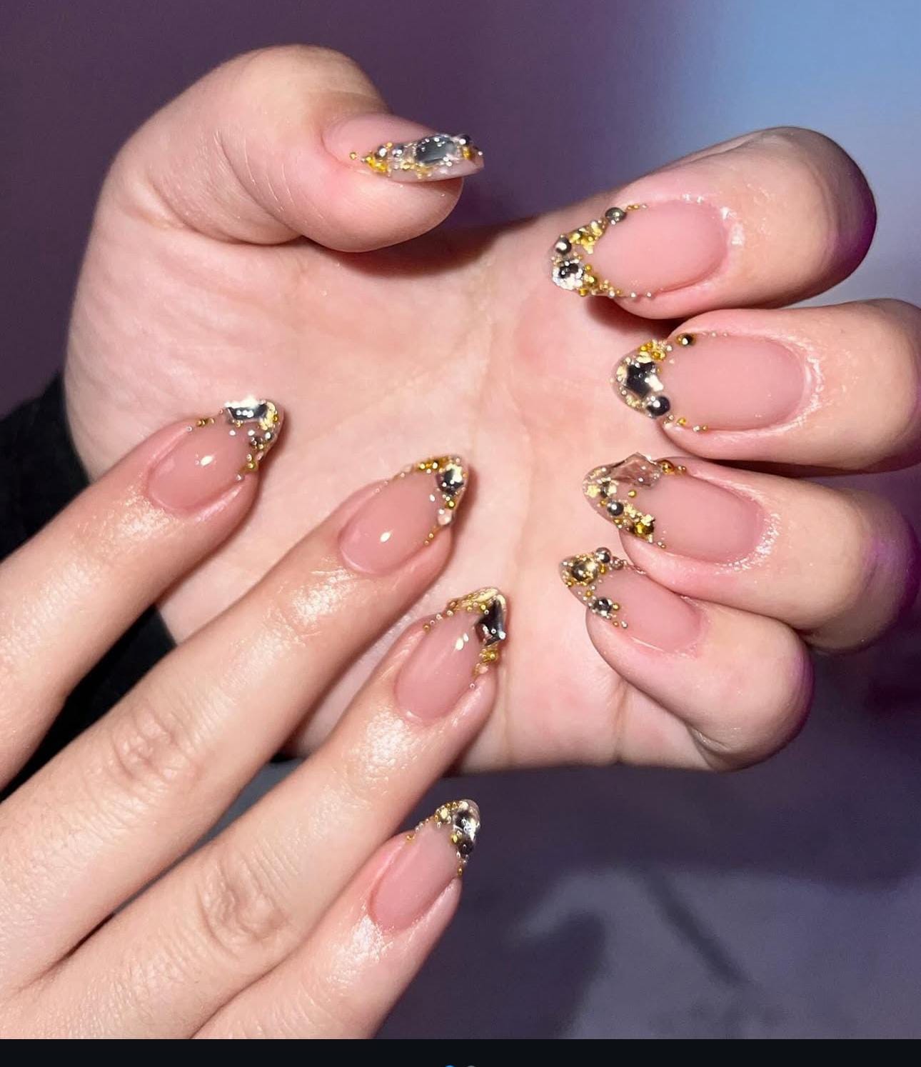 Hand wearing nude Almond -shaped press-on nails