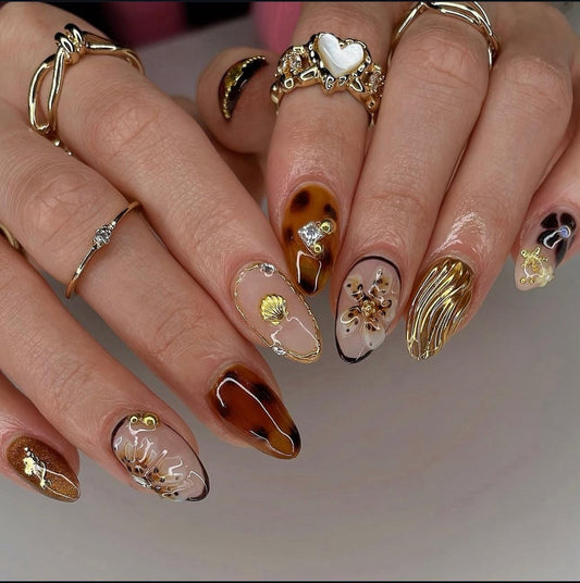 Hand wearing brown Almond -shaped press-on nails