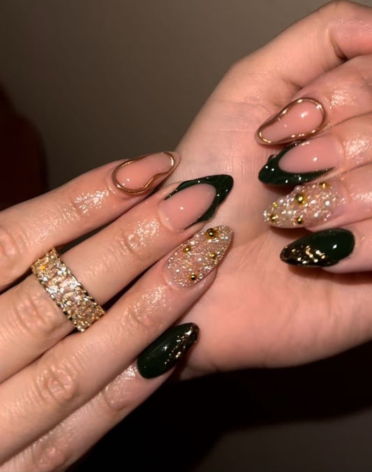 Hand wearing golden eclipse Almond -shaped press-on nails