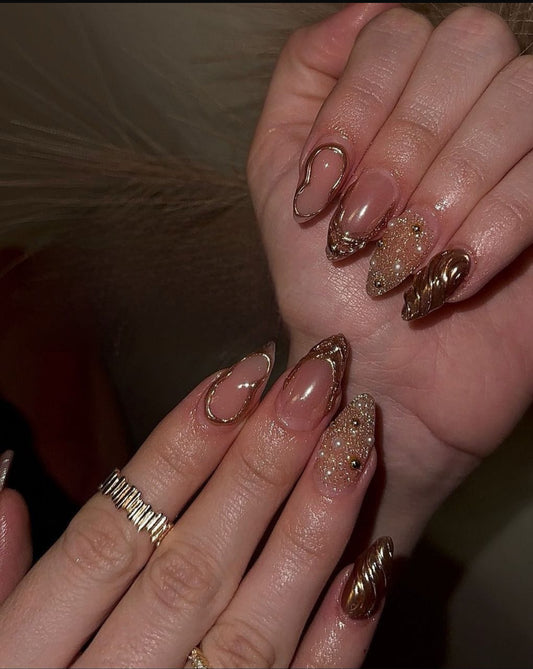 Hand wearing golden luxe -shaped press-on nails