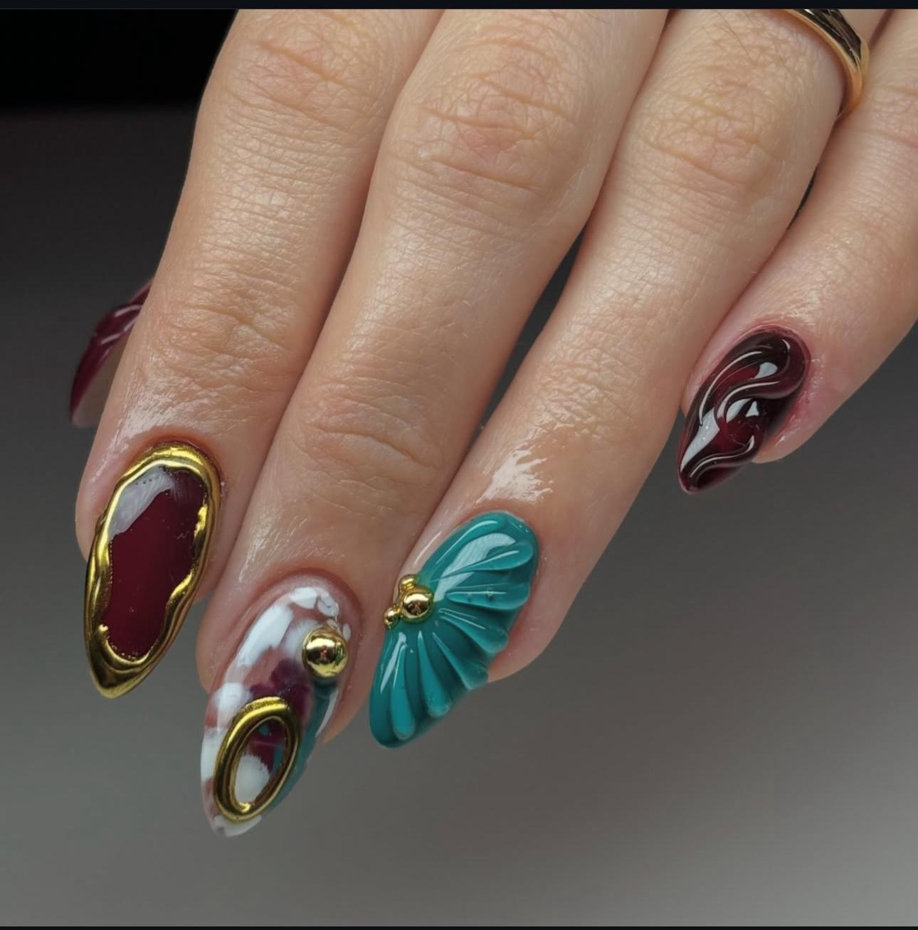 Hand wearing gold Almond -shaped press-on nails