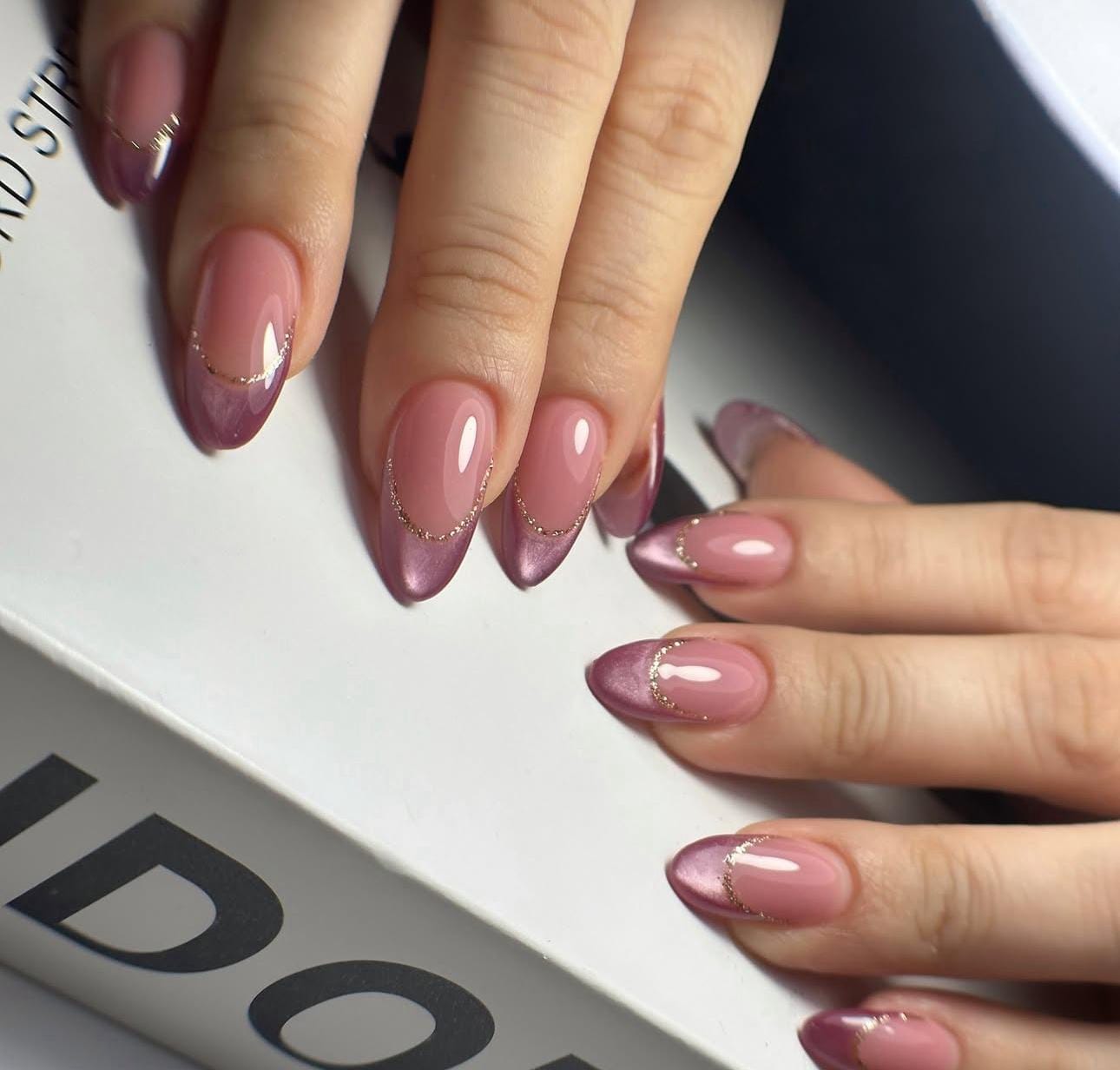 Hand wearing rose gold Almond -shaped press-on nails