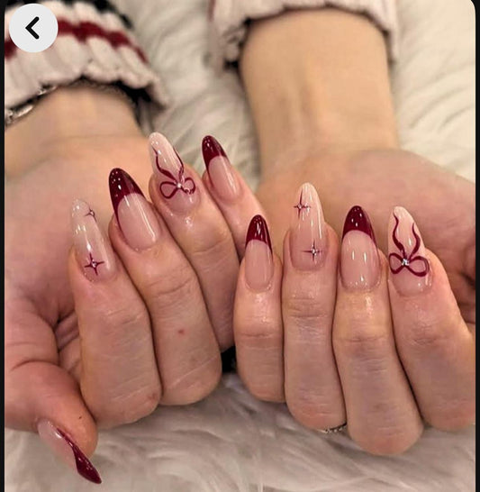 Hand wearing French red tips Almond -shaped press-on nails